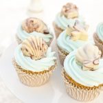 chocoloate seashells sitting on cupcakes
